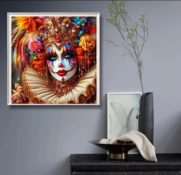 Mounted on a wall in a crisp white frame: A beautiful woman with her face lavishly painted in bright hues of blue, purple,, pink orange and red. She wears a large carnival crown which is adorned in yellow and pink roses, sparkling gems and bright feathers. Around her neck she wears an elaborate gold jeweled choker and a large white ruffled collar. She invokes the spirit of a true carnival queen.