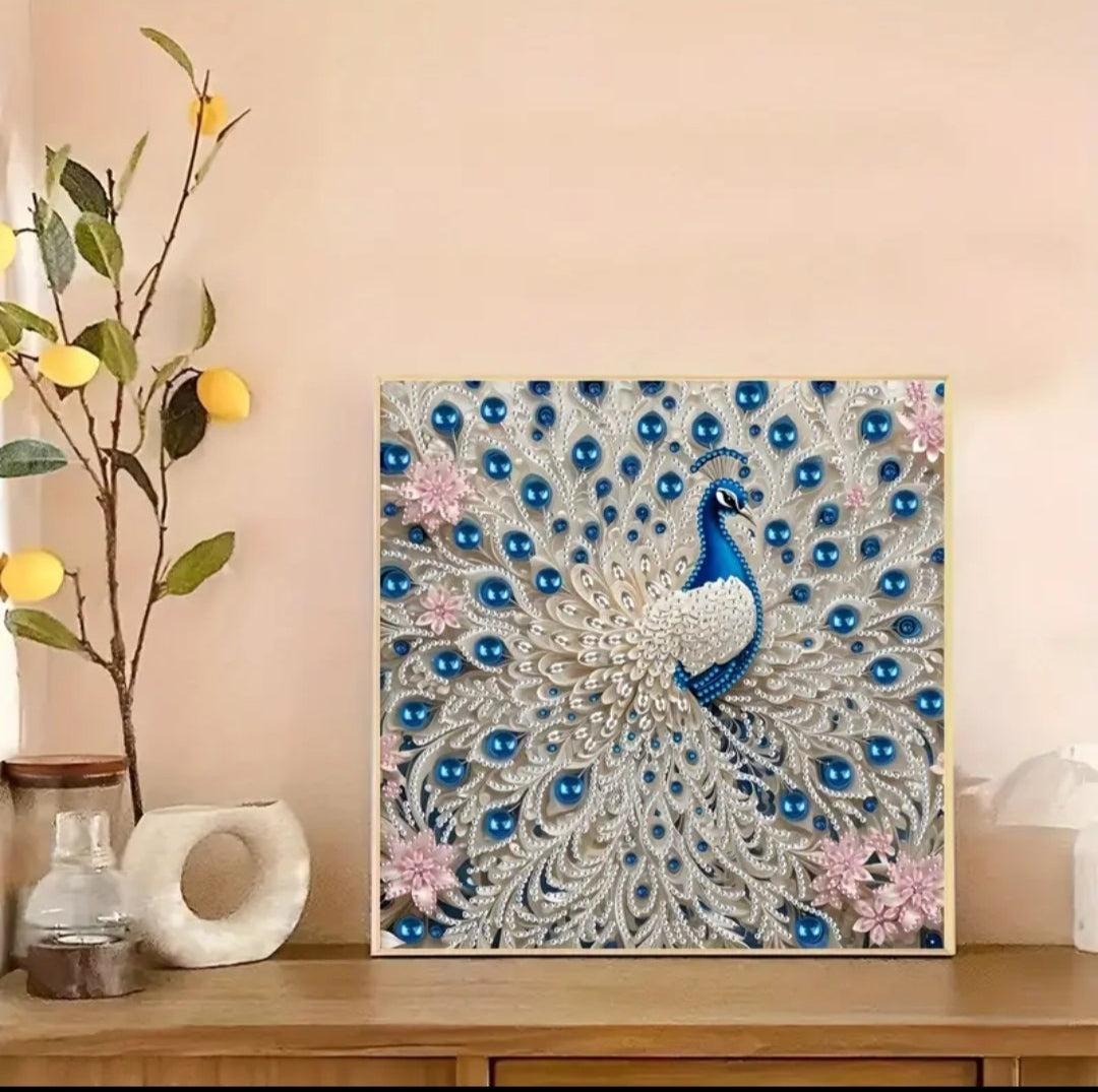 A close up of the diamond peacock detailing the high shine and quality of the beads as well as the intricacy of the piece. The bright blue white and pink diamonds sparkle giving this elegant piece every inch of glamour it deserves. Framed in a thin gold frame and mounted on a fancy credenza.
