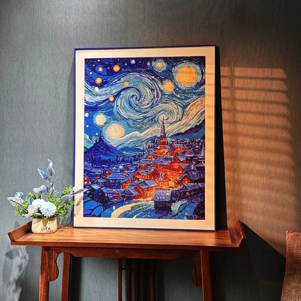 Diamond Painting resembling 'Starry Night' by Van Gogh on a wooden table with decorative elements.