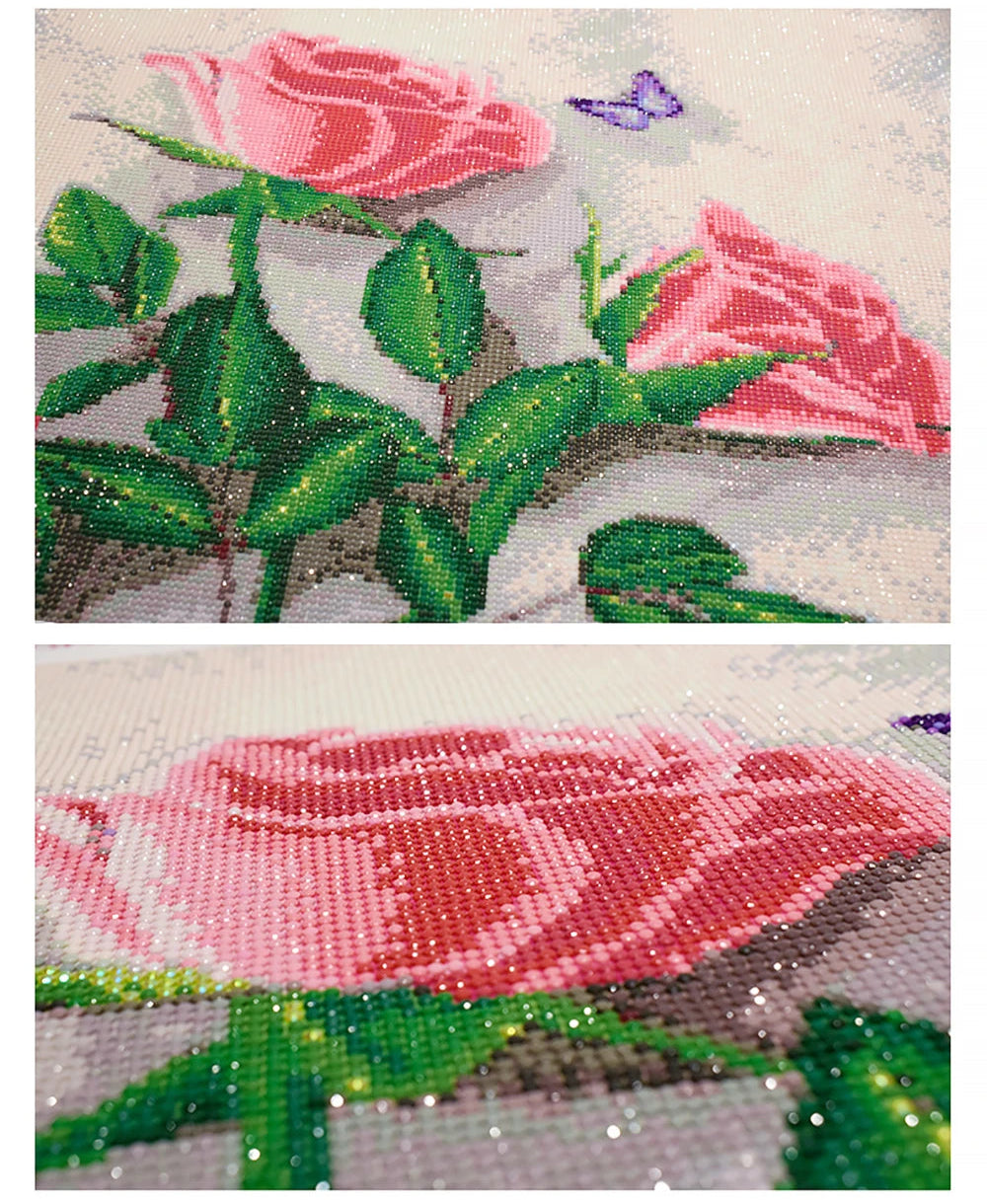 Close-up of a diamond painting with pink roses and green leaves.