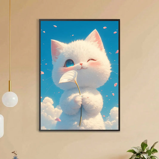 a diamond painting of a soft fluffy snowball white kitten clutches a white lily and winks playfully with his tiny face turned up to a dazzling blue sky