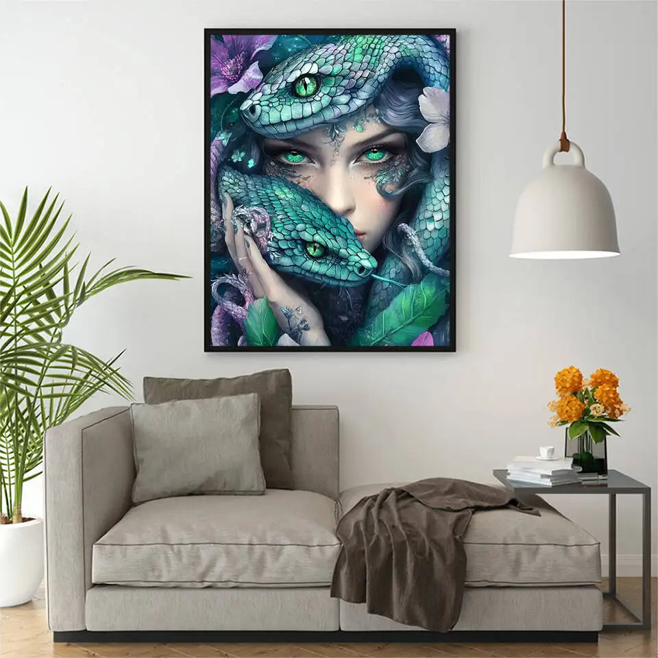 A vibrant and engaging Diamond painting of a mysterious woman with deep green eyes and 2 green snakes coiled around her in a minimalistic black frame mounted in a stylish apartment. 