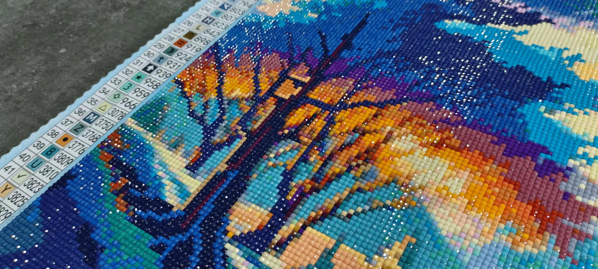 DIY diamond painting kit with a tree design on a blue background