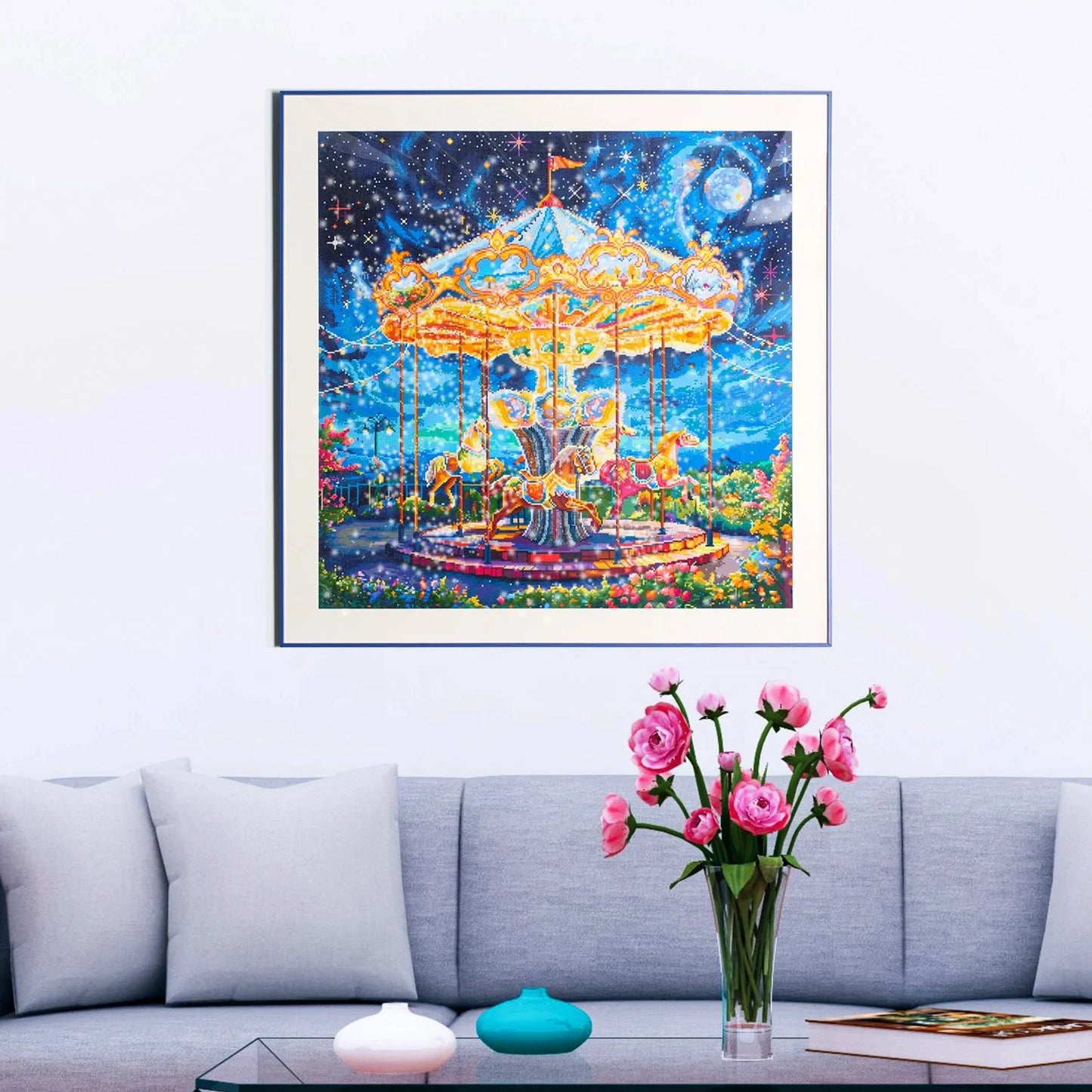 Framed diamond Painting of a carousel against a starry night sky above a sofa with a vase of flowers.